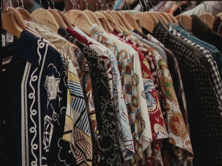 a car parked next to a bunch of clothes