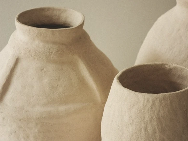 brown clay jars on white table