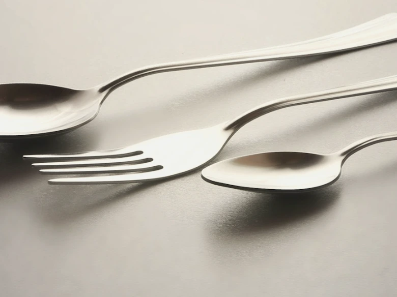 silver spoon and fork on white table