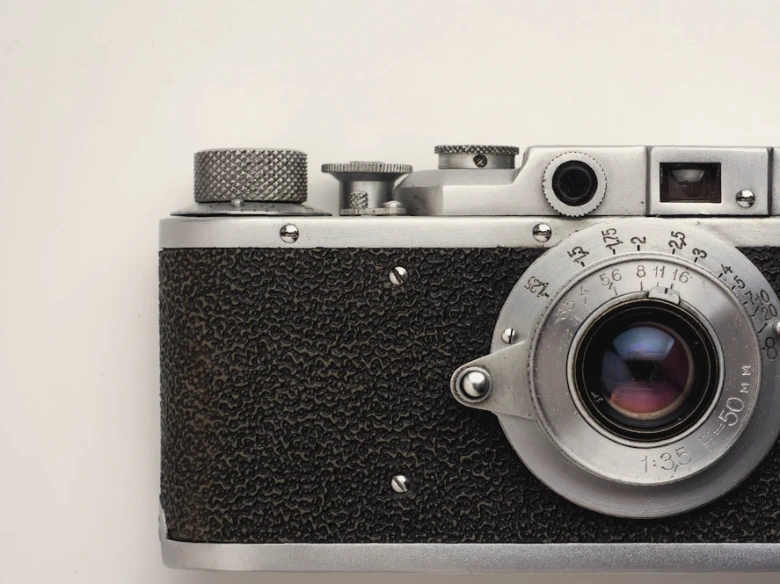 black and gray SLR camera on white background
